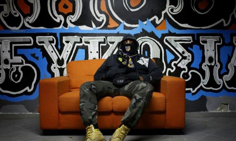 A member of the APOEL ultras, supporting Nicosia's football team of the same name, sits at their fan club headquarters in the Cypriot capital