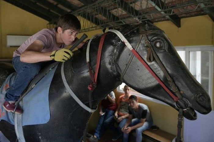 Apprentice Lucas Berticelli rides a mechanical racehorse at the San Isidro Jockey Club school on the outskirts of Buenos Aires