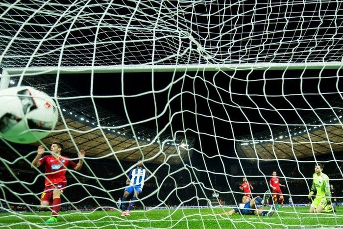 Hoffenheim's forward Andrej Kramaric (L) scores his side's 3rd goal past Hertha Berlin's goalkeeper Rune Jarstein (R) during the German First division Bundesliga football match March 31, 2017
