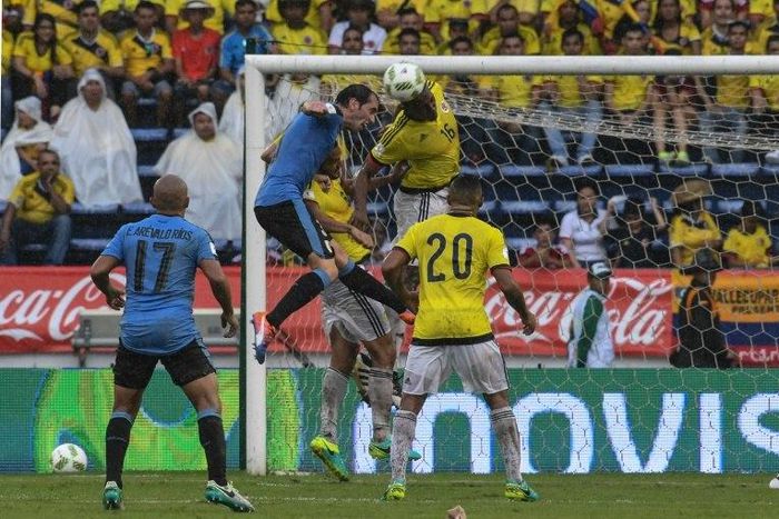 Uruguay's Diego Godin (2nd L) and Colombia's defender Yerry Mina (2nd R) jump for a header during their Russia 2018 FIFA World Cup qualifier football match in Barranquilla, Colombia, on October 11, 2016