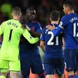 Manchester United's goalkeeper David de Gea (L) is thanked by defender Eric Bailly on October 17, 2016