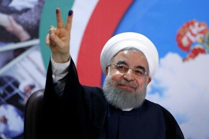 Iranian President Hassan Rouhani gestures to the camera after registering to run for re-election at the interior ministry in Tehran on April 14, 2017