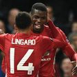 Manchester United's Paul Pogba (R) and Jesse Lingard (L) celebrate after Pogba scored their third goal against Fenerbahce in Manchester, on October 20, 2016.