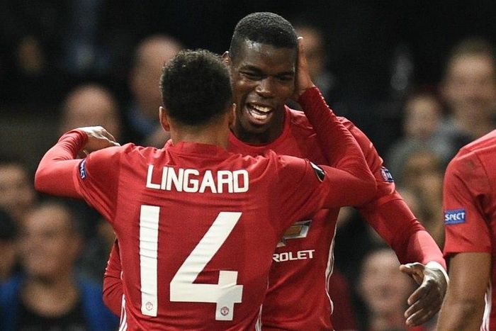 Manchester United's Paul Pogba (R) and Jesse Lingard (L) celebrate after Pogba scored their third goal against Fenerbahce in Manchester, on October 20, 2016.