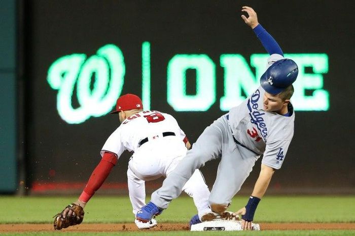 Joc Pederson of the Los Angeles Dodgers advances to second base against Danny Espinosa of the Washington Nationals on October 13, 2016 in Washington, DC