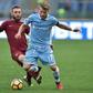 Roma's midfielder from Italy Daniele De Rossi (L) tackles Lazio's forward from Italy Ciro Immobile during the Italian Serie A football match SS Lazio vs AS Roma on December 4, 2016