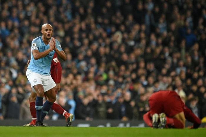 Manchester City's Vincent Kompany reacts after fouling Liverpool's Mohamed Salah