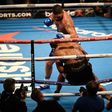 British boxer Tony Bellew (top) punches British Boxer David Haye through the ropes to win their heavyweight boxing match at the O2 arena in London on March 4, 2017