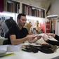 Serkan Cura, left, one of the world's top plumassiers, examines a feather design with Olivier Portais of the French wedding dress label Cymbeline