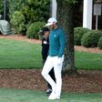 Dustin Johnson of the United States walks with coach Butch Harmon to the practice range during the first round of the 2017 Masters Tournament at Augusta National Golf Club on April 6, 2017 in Augusta, Georgia