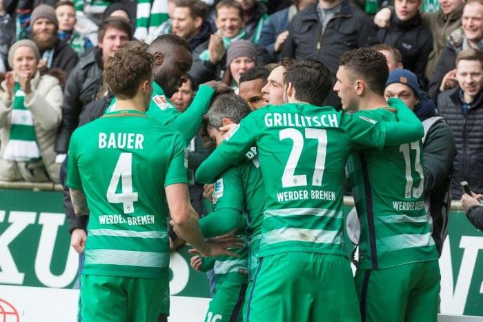 Werder Bremen's players react after scoring the first goal during the German First division Bundesliga football match March 18, 2017