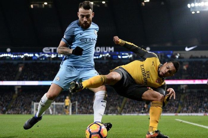 Manchester City's Nicolas Otamendi (left) wins the ball during their 2-1 victory over Arsenal at the Etihad Stadium in December 2016