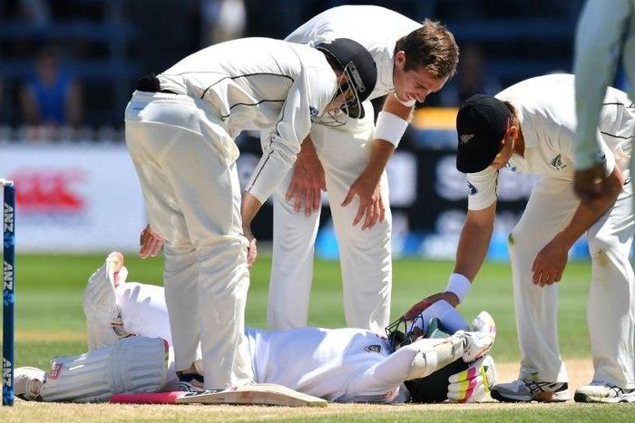 Bangladesh's Mushfiqur Rahim is checked by New Zealand's Tom Latham (L), Tim Southee (C) and Neil Wagner after Rahim was hit in the head during their first Test match, in Wellington, on January 16, 2017