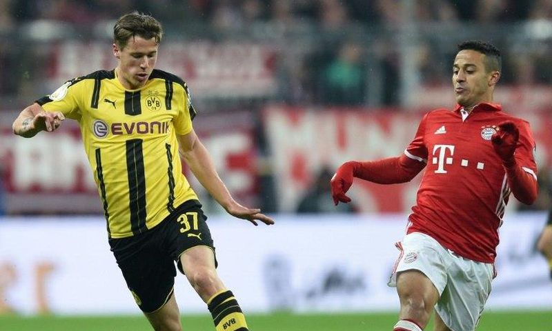 Dortmund's Erik Durm (left) and Bayern Munich's Thiago Alcantara in action during the German Cup semi-final match in Munich, on April 26, 2017