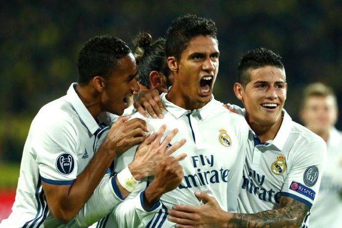 Real Madrid's French defender Raphael Varane (C) celebrates with teammates after scoring a goal during their UEFA Champions League Group F match against Borussia Dortmund, at BVB stadium in Dortmund, on September 27, 2016