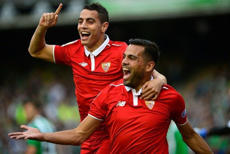 Sevilla's defender Gabriel Mercado (R) celebrates after scoring a goal with forward Wissam Ben Yedder (L) during the Spanish league football match against Real Betis February 25, 2017