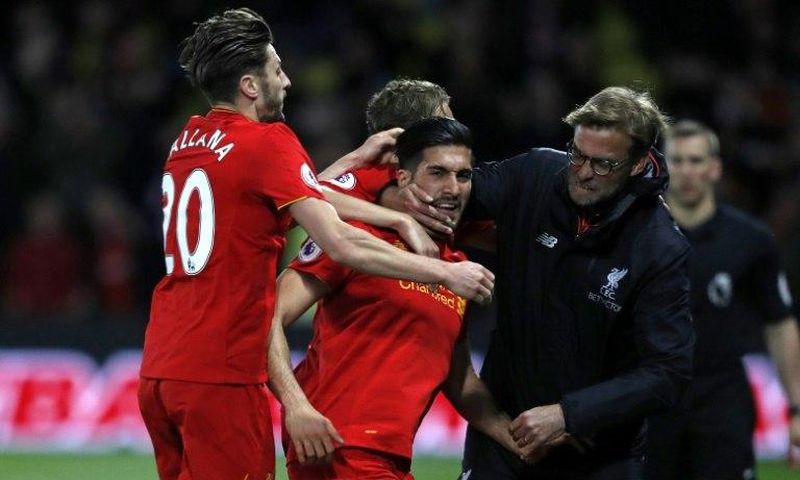 Liverpool's midfielder Emre Can (C) celebrates with Adam Lallana (L) and manager Jurgen Klopp after scoring against Watford on May 1, 2017