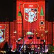 Pictures of candidates for the official mascot of the 2018 FIFA World Cup in Russia, including (L-R) a wolf, a cat and a tiger, are projected onto Moscow State University