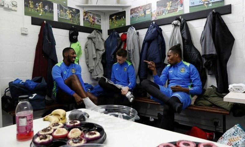 Sutton United players sit in the dressing room ahead of a team training session and media day at The Borough Sports Ground in Sutton, south-west London, on February 16, 2017