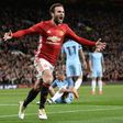 Manchester United's Spanish midfielder Juan Mata celebrates after scoring the opening goal against Manchester City on October 26, 2016