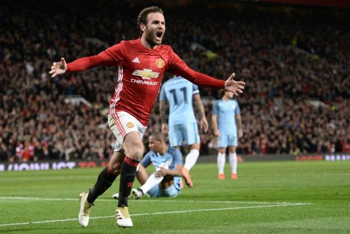 Manchester United's Spanish midfielder Juan Mata celebrates after scoring the opening goal against Manchester City on October 26, 2016
