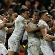 England players celebrate after Elliot Daly (R) scored a second try against Wales at their Six Nations international rugby union match at the Principality Stadium in Cardiff, south Wales, on February 11, 2017