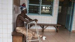 A man who lost his left foot to leprosy, waits for treatment at the Raoul Follereau Foundation facility in Pobe