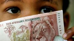 A South African child holds a 50 rand note  in a file photo.