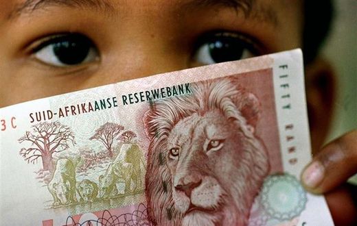 A South African child holds a 50 rand note  in a file photo.