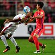 South Korea's Son Heung-Min (R) battles for the ball with Qatar's Pedro Correia during their World Cup qualifier in Suwon on October 6, 2016