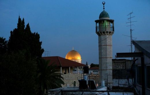 The minaret of a mosque and the Dome of the Rock in a Palestinian neighbourhood in east Jerusalem's Old City
