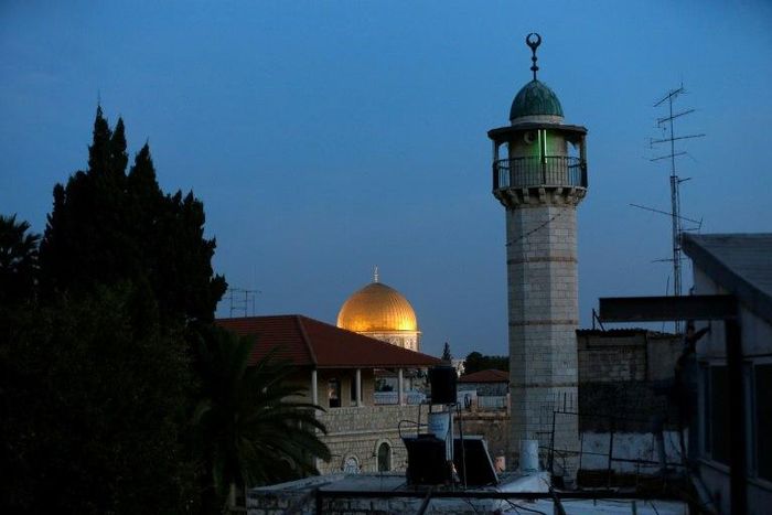 The minaret of a mosque and the Dome of the Rock in a Palestinian neighbourhood in east Jerusalem's Old City