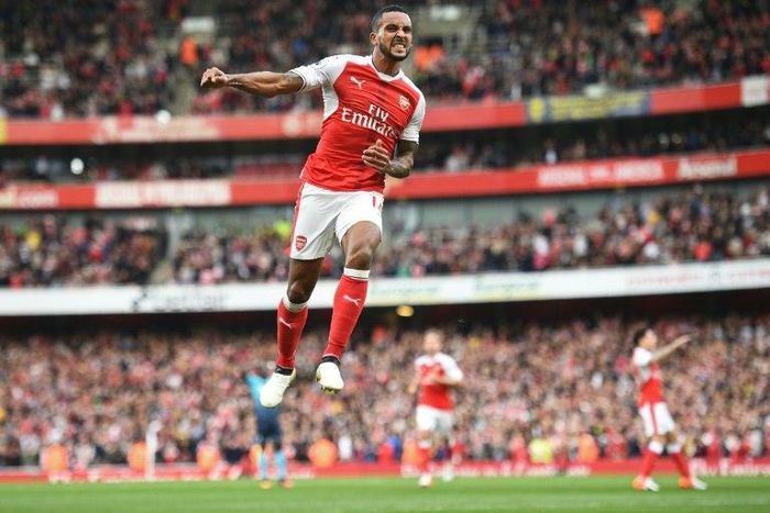 Theo Walcott celebrates after scoring Arsenal's second goal against Swansea City at the Emirates Stadium on October 15, 2016
