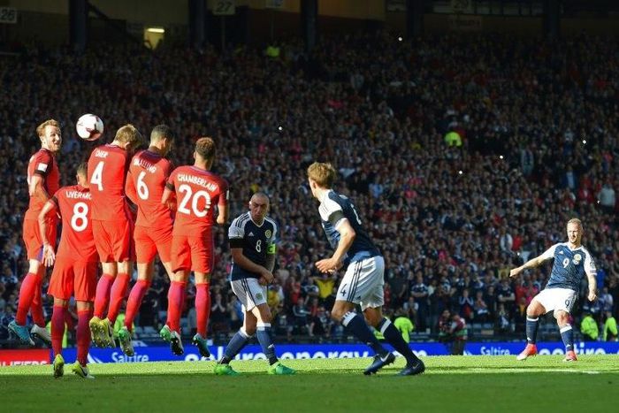 Scotland's striker Leigh Griffiths (R) hits a freekick over the England wall to score their second goal during the group F World Cup qualifying football match between Scotland and England at Hampden Park in Glasgow - the game ended 2-2