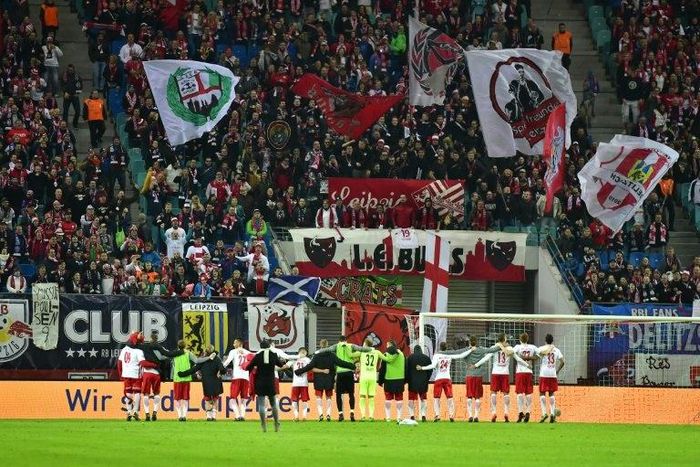 Leipzig's players celebrate with their fans after a German first division Bundesliga football match on November 6, 2016
