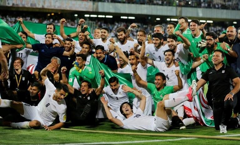Iranian players celebrate after winning the 2018 World Cup qualifying football match between Iran and Uzbekistan on June 12, 2017
