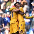 Crystal Palace's Luka Milivojevic (R) and Wilfried Zaha embrace on the pitch at the final whistle of their match against Chelsea at Stamford Bridge in London on April 1, 2017