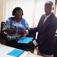 Dr H.N. Akubuiro, (left) the Vice-President of the council of the Chartered Institute of Loans and Risk Management, Nigeria, presenting the memorandum of understanding to Mr Adam Sulley, the President of the Institute of Loans and Risk Management, Ghan...