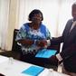 Dr H.N. Akubuiro, (left) the Vice-President of the council of the Chartered Institute of Loans and Risk Management, Nigeria, presenting the memorandum of understanding to Mr Adam Sulley, the President of the Institute of Loans and Risk Management, Ghan...