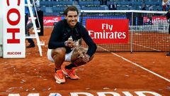 Spanish tennis player Rafael Nadal poses with his trophy as he celebrates his victory over Austrian tennis player Dominic Thiem at the end of the Madrid Masters