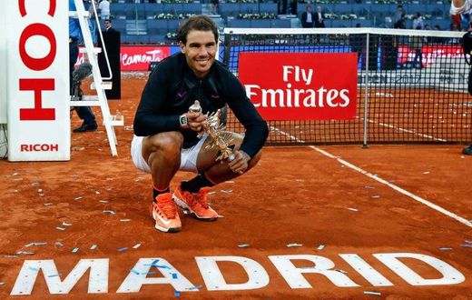 Spanish tennis player Rafael Nadal poses with his trophy as he celebrates his victory over Austrian tennis player Dominic Thiem at the end of the Madrid Masters