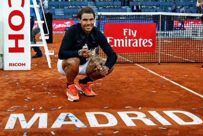 Spanish tennis player Rafael Nadal poses with his trophy as he celebrates his victory over Austrian tennis player Dominic Thiem at the end of the Madrid Masters