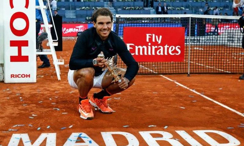 Spanish tennis player Rafael Nadal poses with his trophy as he celebrates his victory over Austrian tennis player Dominic Thiem at the end of the Madrid Masters