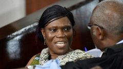 Former Ivorian first lady Simone Gbagbo (L) talks to her lawyer at the Abidjan's courthouse on October 10, 2016 before the re-opening of her trial, during which she was prevented from leaving the courtroom by military police November 29, 2016