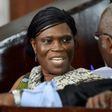 Former Ivorian first lady Simone Gbagbo (L) talks to her lawyer at the Abidjan's courthouse on October 10, 2016 before the re-opening of her trial, during which she was prevented from leaving the courtroom by military police November 29, 2016