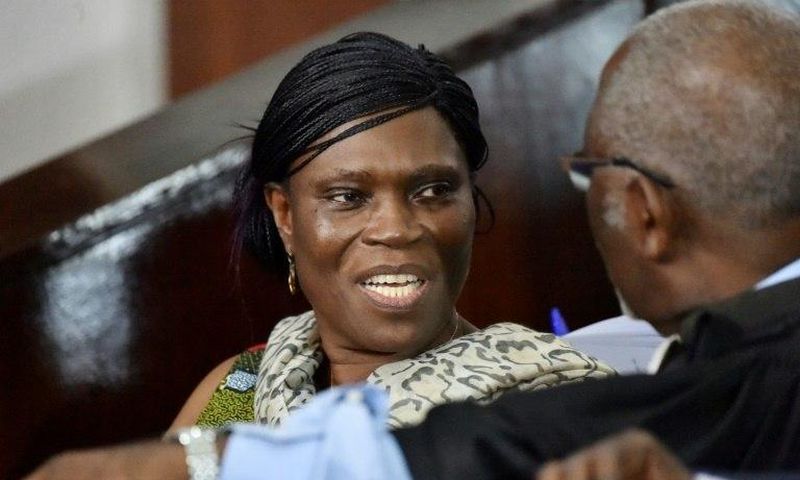 Former Ivorian first lady Simone Gbagbo (L) talks to her lawyer at the Abidjan's courthouse on October 10, 2016 before the re-opening of her trial, during which she was prevented from leaving the courtroom by military police November 29, 2016
