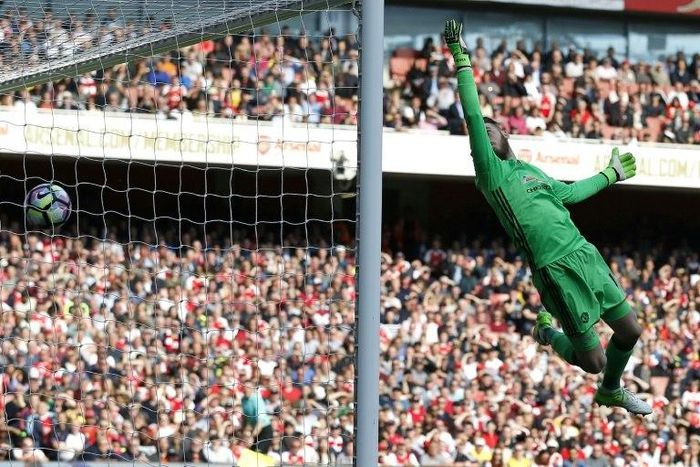 Manchester United's Spanish goalkeeper David de Gea cannot prevent Arsenal's midfielder Granit Xhaka's deflected shot beating him for the opening goal of the English Premier League football match at the Emirates Stadium in London on May 7, 2017