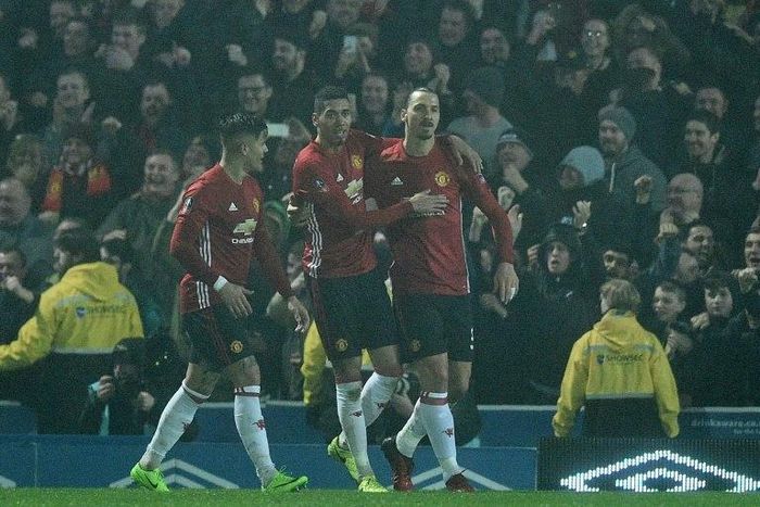 Manchester United's striker Zlatan Ibrahimovic (R) celebrates with teammates after scoring their second goal during the English FA Cup fifth round football match against Blackburn Rovers on February 19, 2017