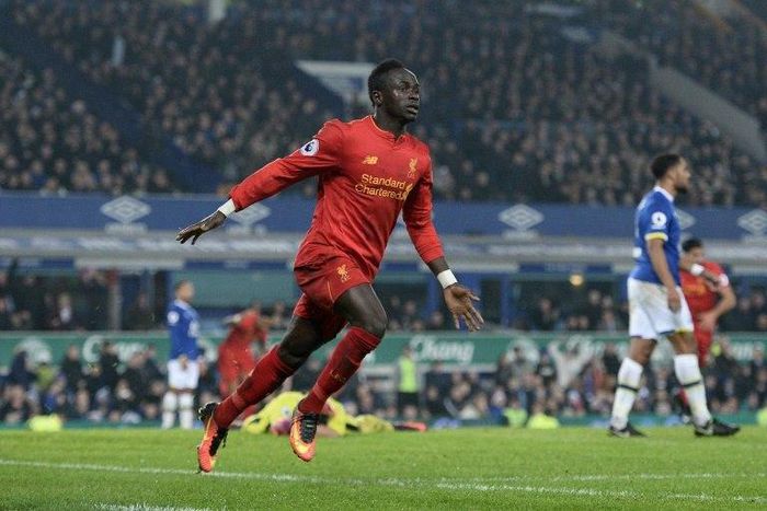 Liverpool's Senegalese midfielder Sadio Mane celebrates scoring his team's first goal during the English Premier League football match between Everton and Liverpool at Goodison Park in Liverpool, north west England on December 19, 2016