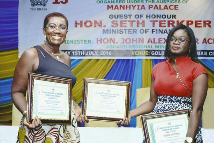 FROM LEFT: NANA EFUA ROCKSON (GROUP HEAD, CORPORATE AFFAIRS & MARKETING FOR GLICO GROUP) DISPLAYING THE AWARDS WITH JENNIFER SIRA DARTEH (BUSINESS DEVELOPMENT OFFICER FOR GLICO GENERAL) 